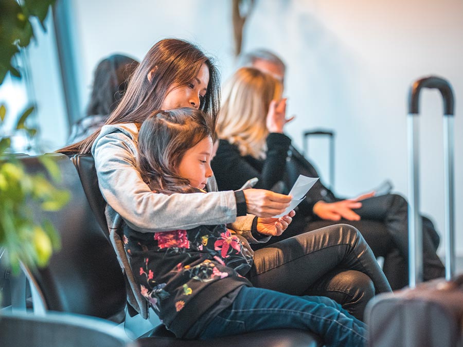 Mother and child waiting in airport departure lounge