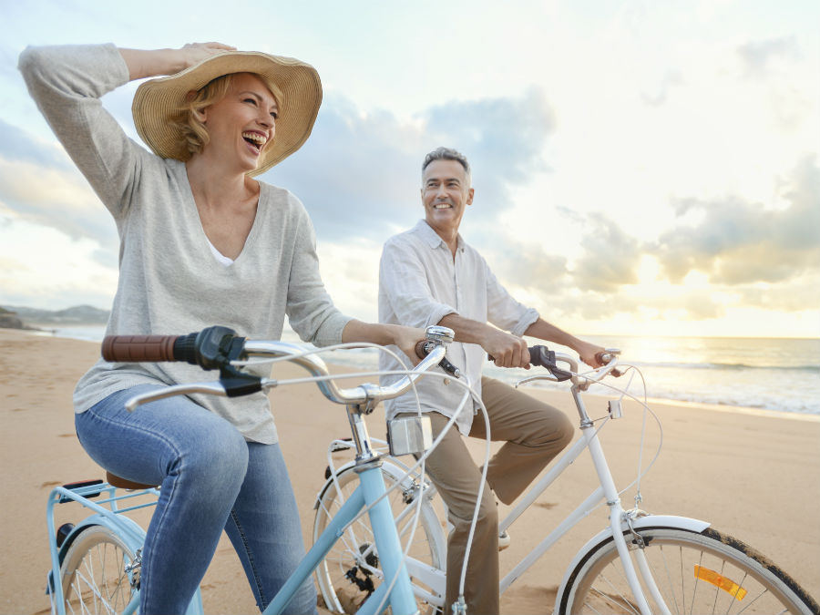 Couple cycling on the beach