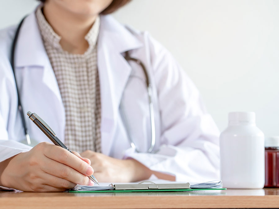 A doctor writing a script for medication